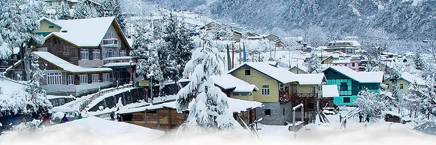 Lachung town in Sikkim covered in snow with frozen waterfalls and alpine landscapes