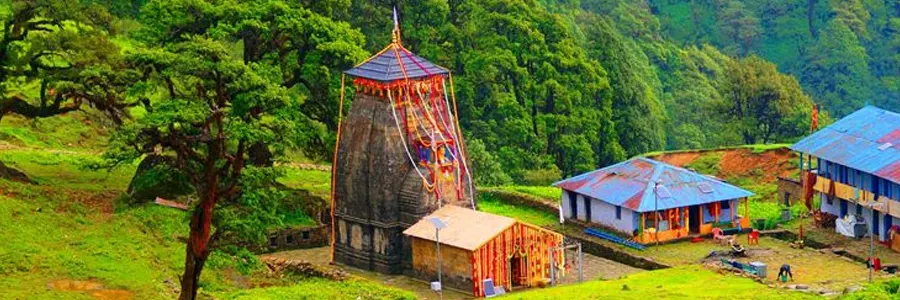 Madhyamaheshwar Temple with green meadows in Uttarakhand
